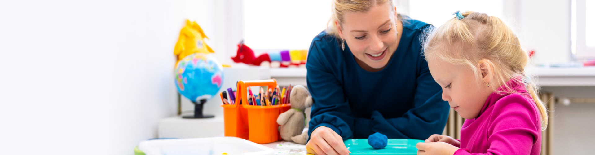 woman playing clay with toddler